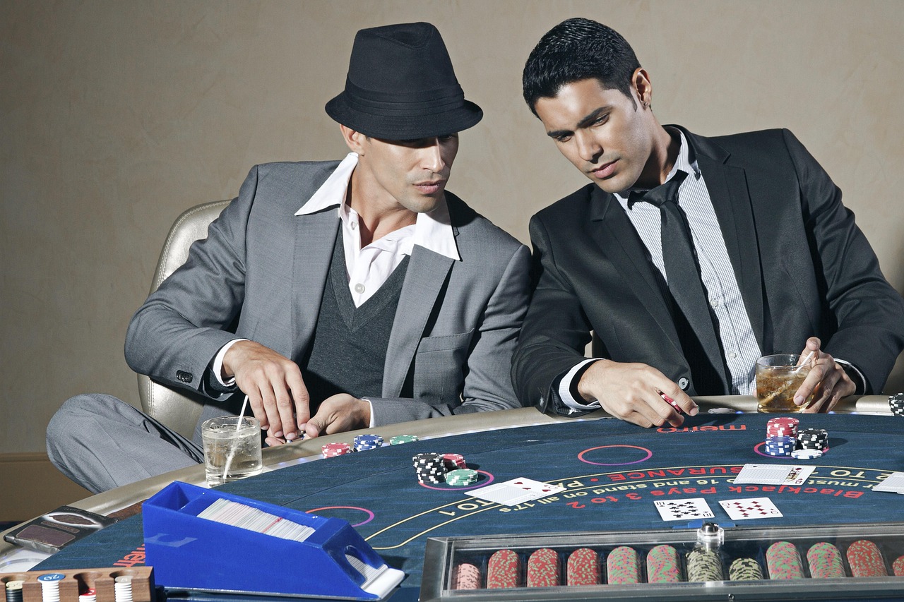 Blackjack table with cards and dealer — the canonical game of 21